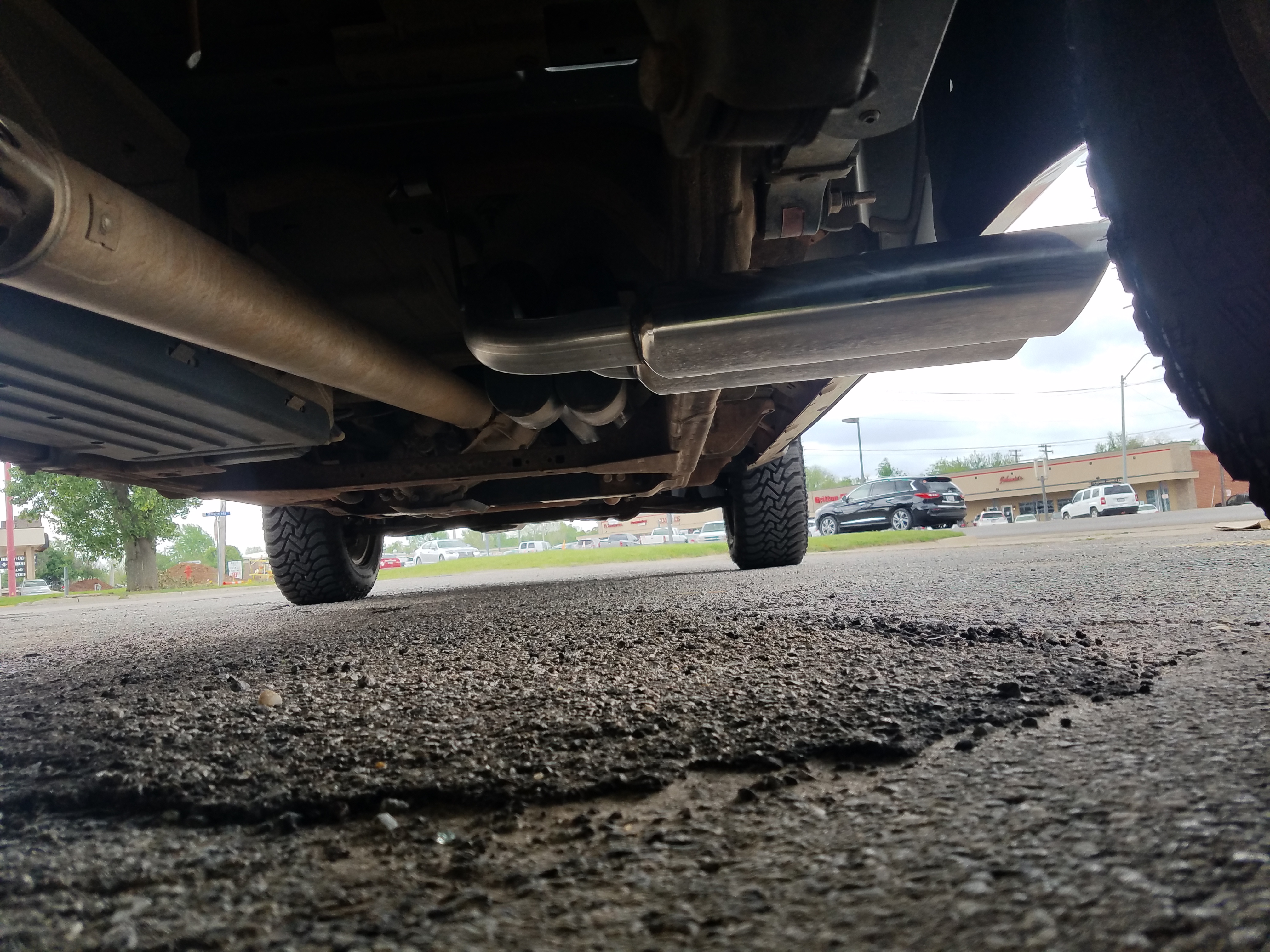 20170413_121227 2013 Chevy Silverado that the customer requested true dual exhaust with both tailpipes and tips exiting out of the passenger side of the truck, in front of the rear tire. We call these "shotgun" tailpipes.